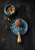 Chocolate ice cream with nuts in an ice cream scoop