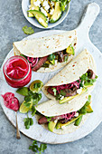 Beef fajitas with avocado, fetta and pickled onion