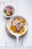 Minute schnitzel with fried potatoes and a radish salad