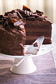 A three-layer chocolate cream cake, sliced