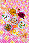 A selection of Indian food with various bowls of food (seen from above)