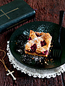 A slice of Linzer Torte (nut and jam layer cake)