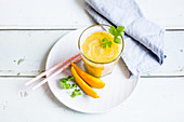 Mango smoothie with banana and parsley