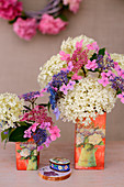 Various hydrangeas in vases decorated using napkin decoupage