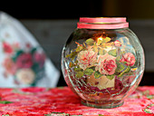 Romantic candle lantern decorated with rose motif in napkin decoupage