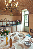 Set table in Mediterranean kitchen with vaulted ceiling