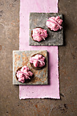 Herring salad with beetroot and red onions on pumpernickel bread