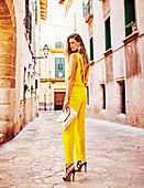 A young woman wearing a yellow jumpsuit