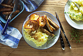 Sausages with mashed potatoes and fried apple rings