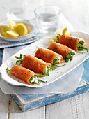 Smoked salmon rolls with cream cheese and rocket
