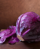 Whole Head of Purple Cabbage on Wooden Cutting Board