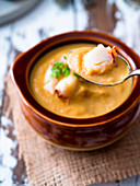 Creamy soup topped with lobster