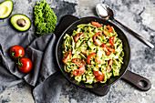 Tagliatelle with green kale pesto and tomatoes