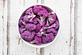 Organic purple cauliflower in a white bowl