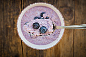 Spoon of overnight oats with blueberries, close-up