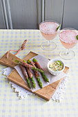 Green asparagus wrapped in ham with bearnaise sauce and strawberry cocktails