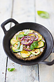 Low-carb mini tarte flambée made with a chickpea and sunflower seed dough topped with courgette and red onions