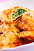 Agnolotti filled with spinach in tomato sauce