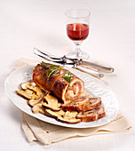 A veal roll with prosciutto and porcini mushrooms