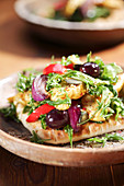 Pitta bread filled with curried chicken, rocket, onions, peppers and olives