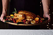 Winter roast chicken with fruit and vegetables being served