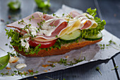 A sandwich with ham, cheese, mayonnaise and cress