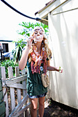 A young blonde woman blowing bubbles