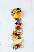 Close up of tasty breakfast or smoothie ingredients. Various grains, seeds, fresh berries and fruits on white rustic backdrop