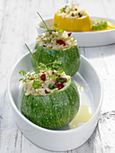 Round zucchinis stuffed with rice and pomegranate seeds