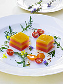Red and yellow tomato terrine with hyssop and rocket