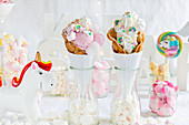 A candy bar table with bubble waffles and unicorn decorations