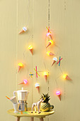Summery ice-cream-cone fairy lights on yellow wall