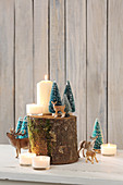 Wintry still-life arrangements with animal figurines, tiny trees and candles