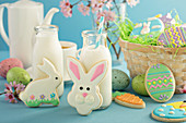 Easter cookies on blue table with milk in little bottles