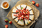 Fresh yogurt tart with macerated strawberries, mint and honey