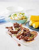 Spare ribs with herby potato salad and corn