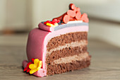 A slice of chocolate cake decorated with marzipan