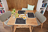 Place mats handmade from chalkboard fabric on rustic wooden table