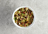 Grated brussels sprouts with maple syrup glazed pecans and pomegranate seeds