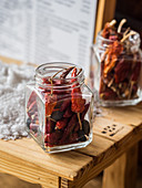 Dried red chili peppers in screw top jars