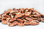 Pecan kernels on a white surface