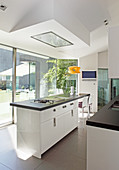 Island counter and glass wall in modern designer kitchen