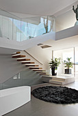 Bathtub below staircase in open-plan architect-designed house