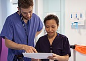 Doctor and nurse discussing patient notes