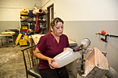 Disabled worker making prosthetic leg, Mexico