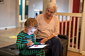 Grandmother and grandson using tablet computer