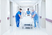 Medical team pushing patient on bed