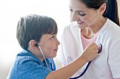 Boy and nurse playing with stethoscope