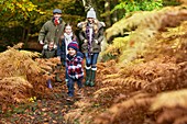 Family walking in woods in Autumn