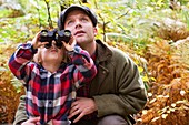 Father and son with binoculars